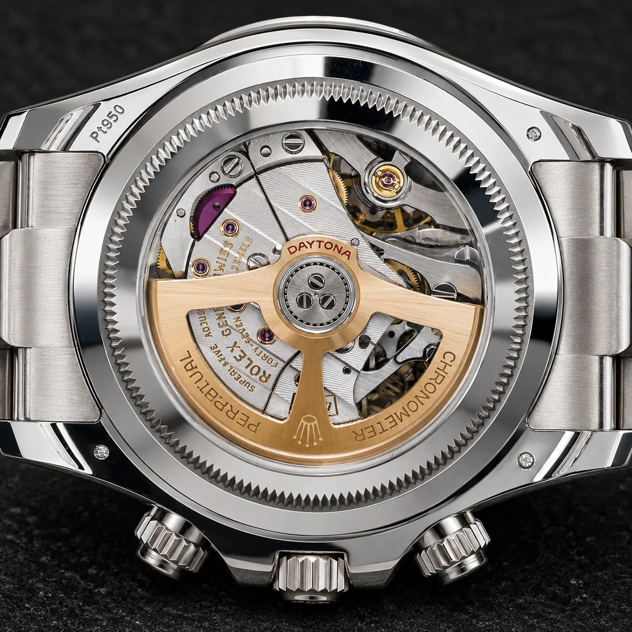 Macro close-up of a Rolex Daytona automatic movement featuring a gold rotor, visible chronograph components, jewel bearings, and intricate mechanical finishing displayed through a transparent sapphire caseback.